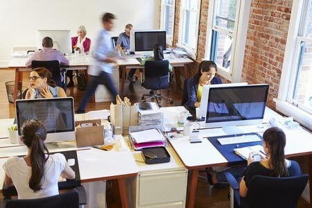 Young employees work in busy office