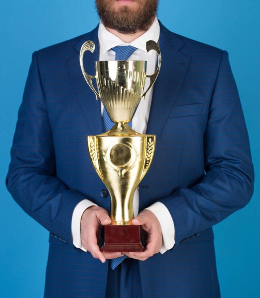 Business man holds a trophy