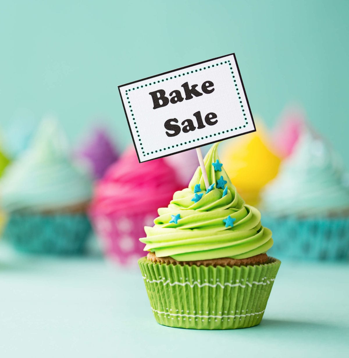 Cupcake with sign that says "Bake Sale"