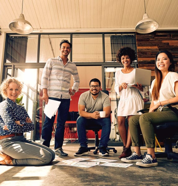 Young coworkers gather for a meeting in hip office