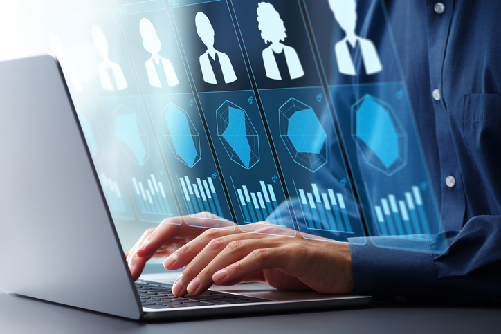 View of a person using a laptop for a virtual meeting, showcasing the use of AI interviewing tools in modern hiring.